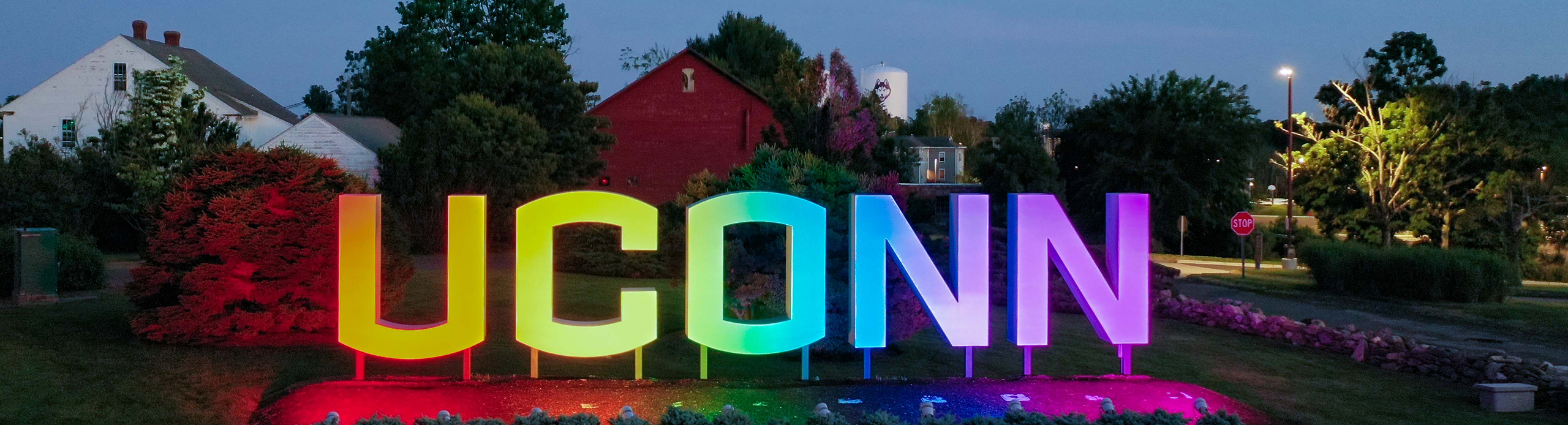 UConn sign lit up in rainbow gradient.